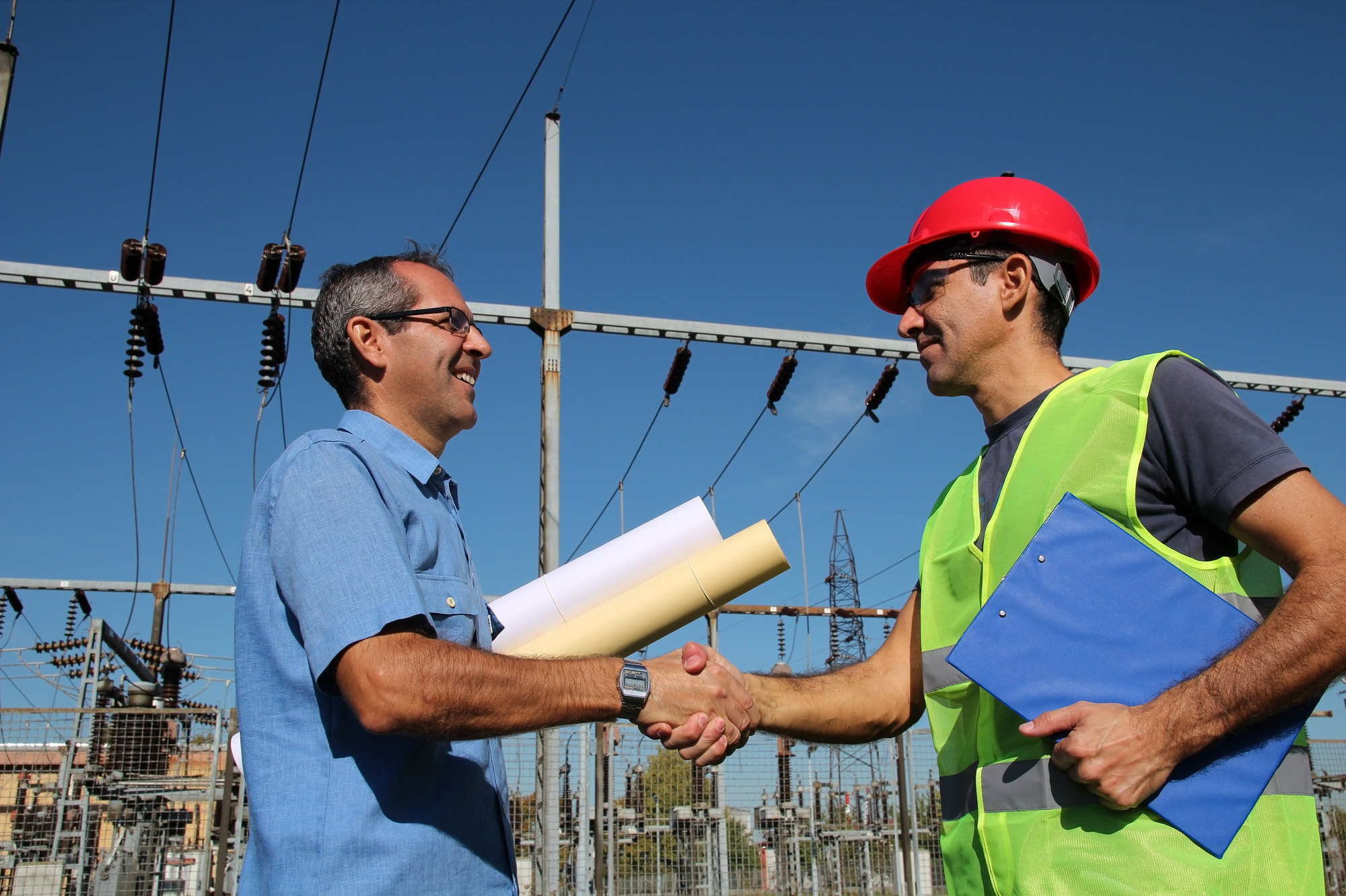 Engineer And Worker At Electrical Substation.